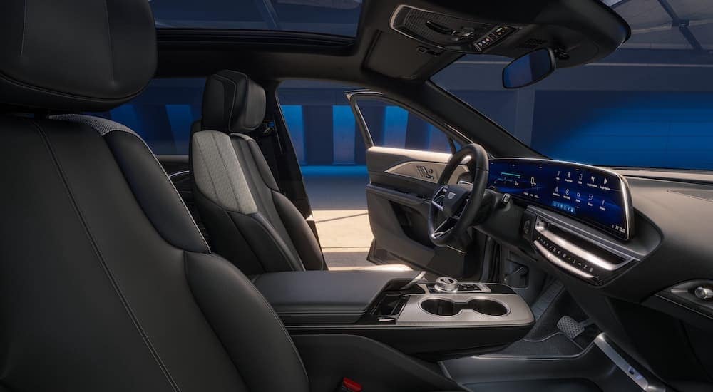 The black interior of a 2024 Cadillac LYRIQ is shown from the passenger side.